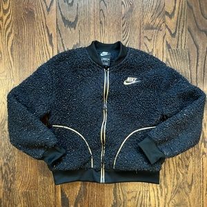 Nike Black lightweight coat. Zip front. Specks of gold. Girls large.